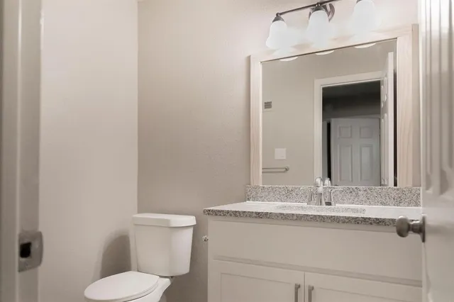 a bathroom with a sink vanity and a mirror