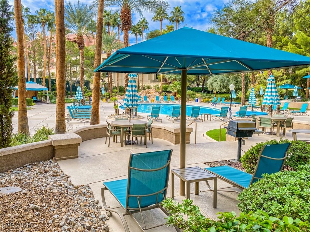 260 East Flamingo Road, Unit 229 Las Vegas, NV 89169 - Photo 2 of 31 View of patio / terrace featuring grilling area, a community pool, and outdoor dining space