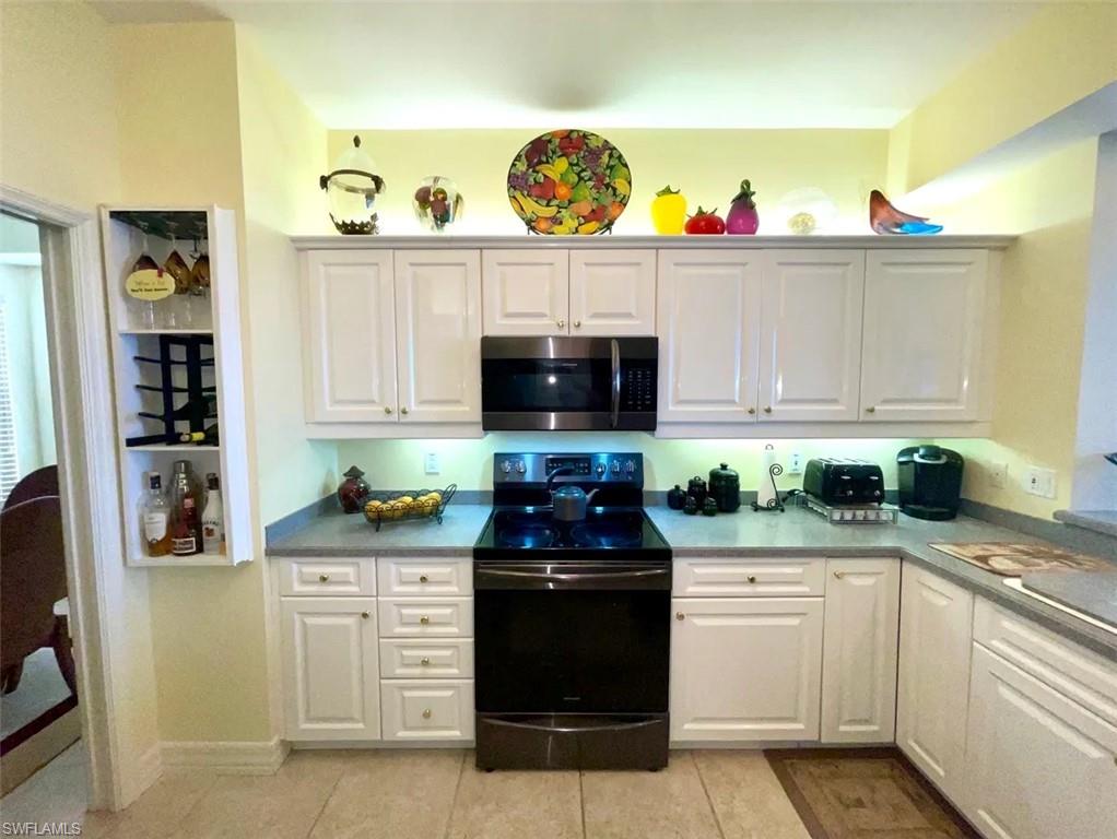 451 Bayfront Place, Unit 5311 Naples, FL 34102 - Photo 18 of 38 a kitchen with stainless steel appliances granite countertop a sink and a stove