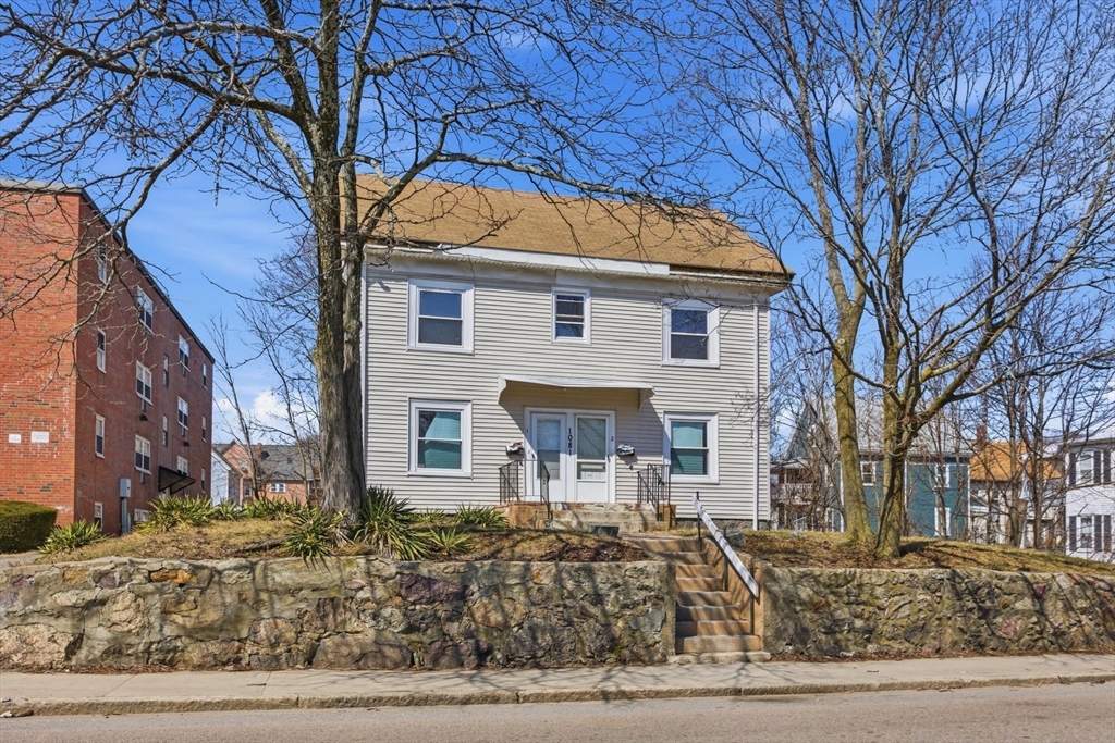 1081 River Street Boston, MA 02136 - Photo 1 of 8 a front view of a house with trees