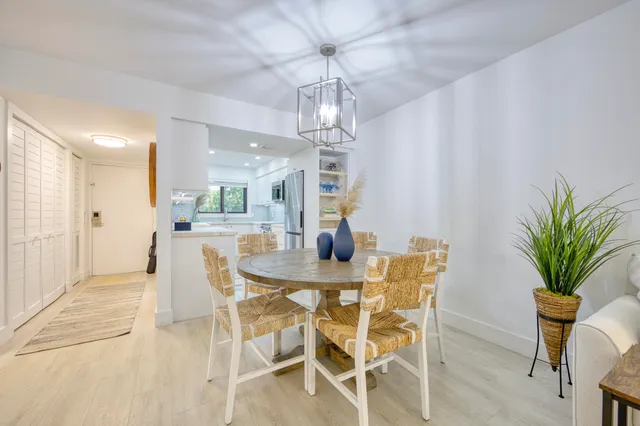 a view of a dining room with furniture and chandelier