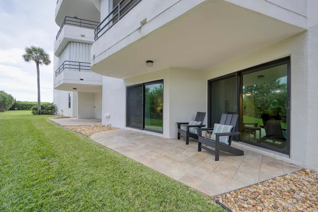 a view of a house with backyard sitting area and garden