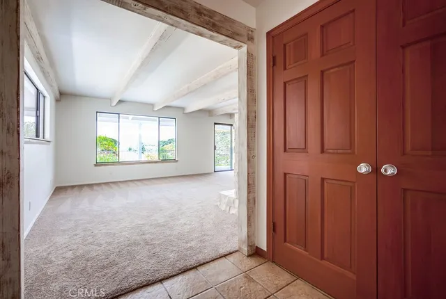 an empty room with windows and closet