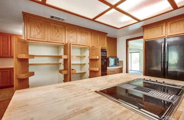 a large kitchen with a stove and a window