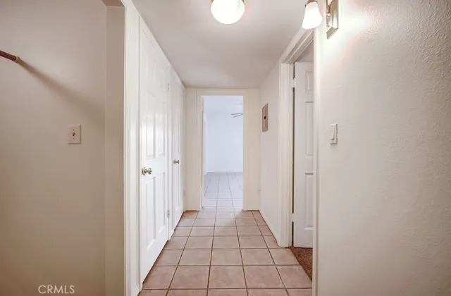 en empty room with fan and a ceiling fan