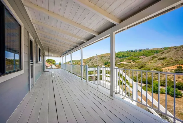 a view of a balcony with wooden floor