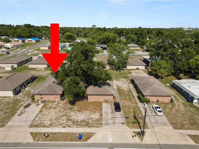 an aerial view of residential houses with outdoor space and swimming pool