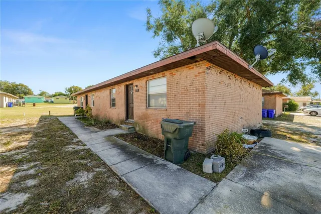 a view of a house with backyard and sitting area