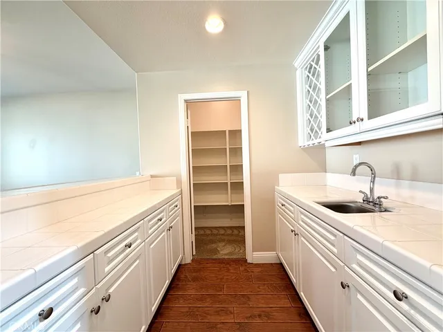 a large kitchen with kitchen island a stove a sink a center island and cabinets