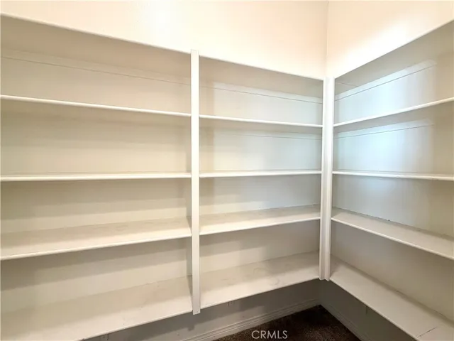 a large kitchen with stainless steel appliances granite countertop a stove a sink dishwasher and a refrigerator with wooden floor