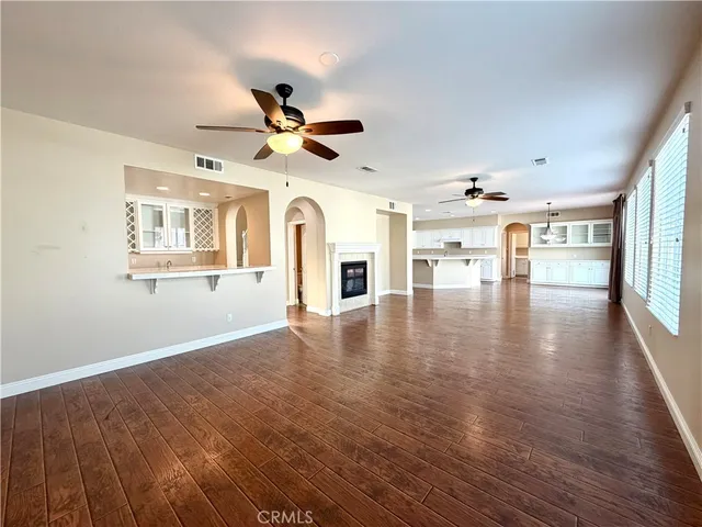 a kitchen with stainless steel appliances cabinets and wooden floor