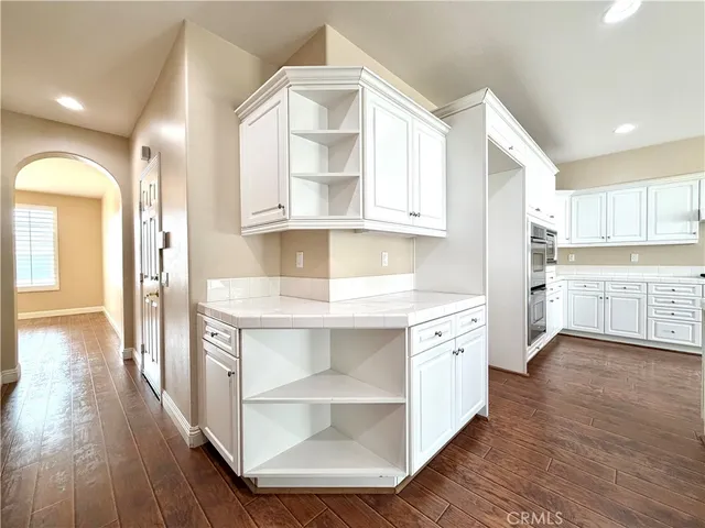a bathroom with a bathtub shower sink vanity and toilet