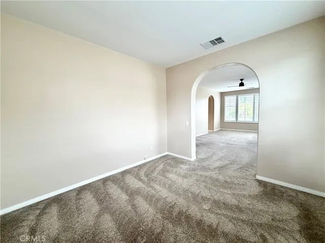 a view of a hallway with wooden floor and door