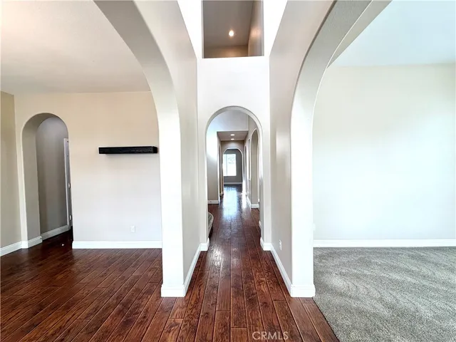 a view of a room with wooden floor and a large window