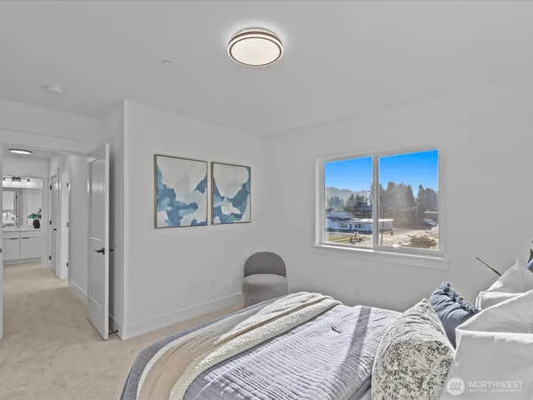 a bedroom with a bed and a painting on the wall