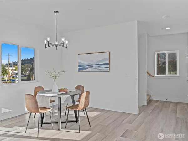 a dining room with furniture and chandelier