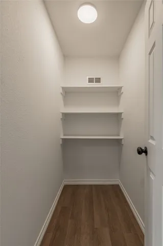 a view of storage and utility room with wooden floor