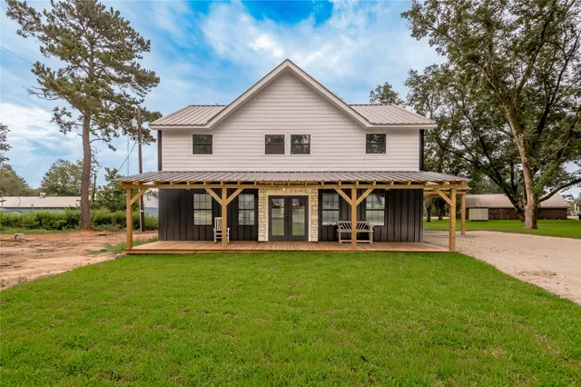a view of a house with a yard and sitting area