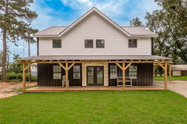 a view of a house with yard and chairs