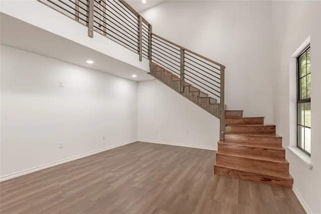 a view of entryway and hall with wooden floor