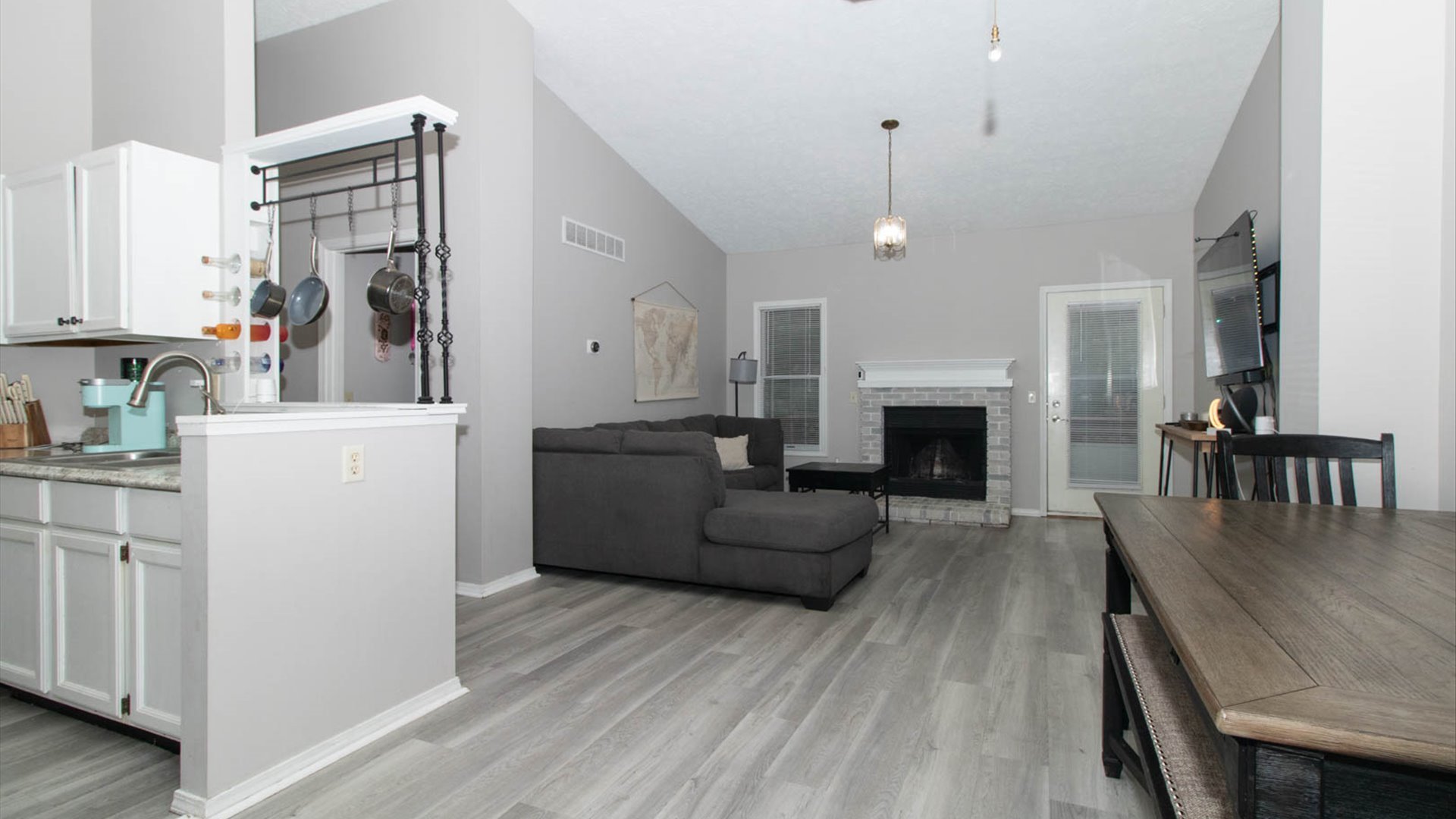 4 Shire Court Bloomington, IL 61701 - Photo 11 of 33 a living room with furniture a fireplace and a flat screen tv