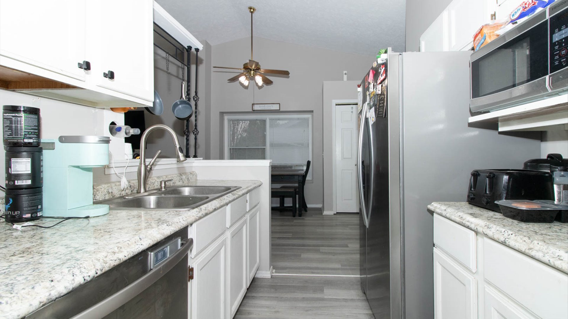 4 Shire Court Bloomington, IL 61701 - Photo 22 of 33 a kitchen with stainless steel appliances granite countertop a sink refrigerator and microwave