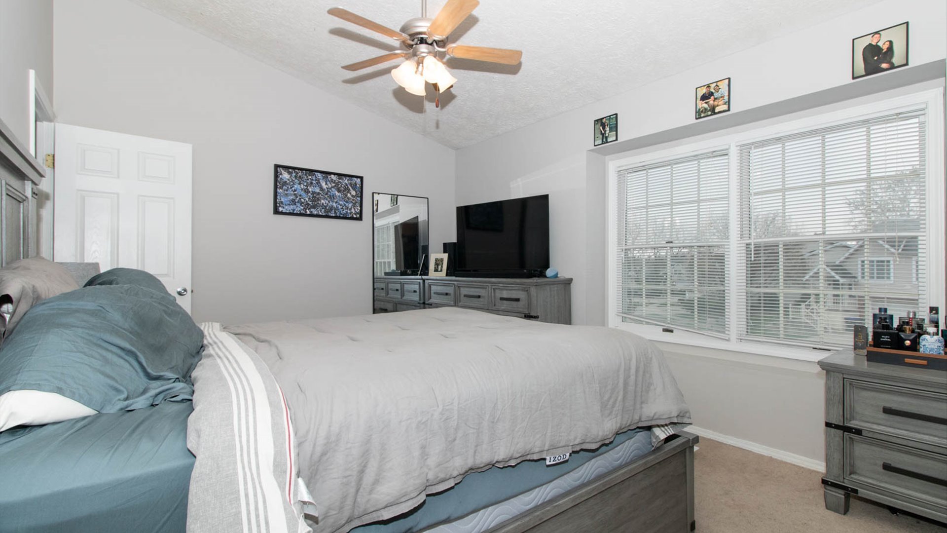 4 Shire Court Bloomington, IL 61701 - Photo 25 of 33 a bedroom with a bed and a flat tv screen on the dresser