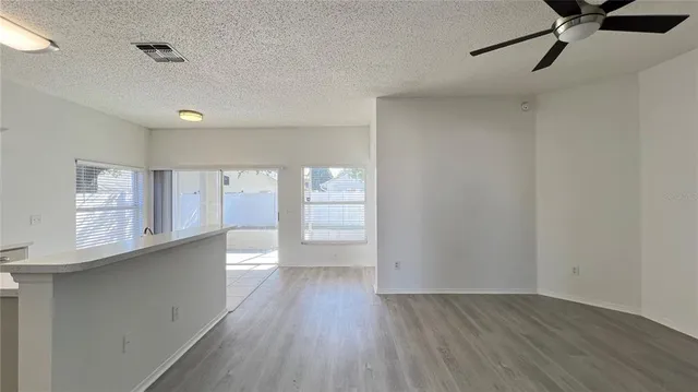 a view of a kitchen with a sink and wooden floor