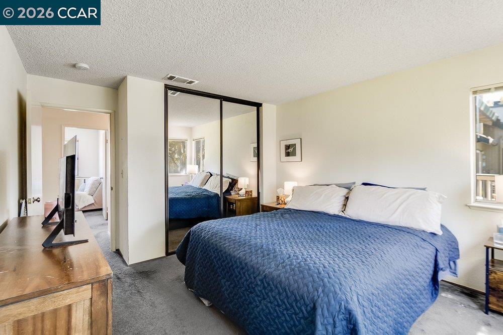 1123 Chadwick Circle Bay Point, CA 94565 - Photo 19 of 26 a bedroom with a bed and a large mirror