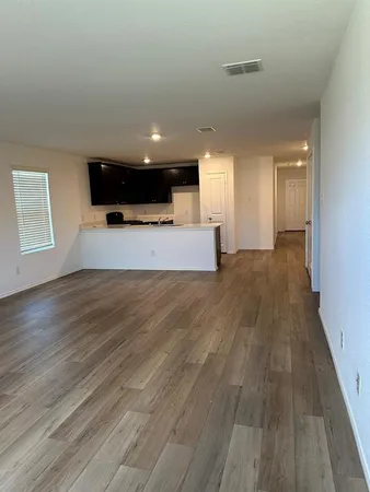a kitchen with wooden cabinets and black appliances