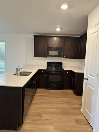 a kitchen with stainless steel appliances a refrigerator and a stove top oven