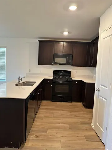 a kitchen with stainless steel appliances a refrigerator and a stove top oven