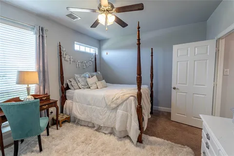 a bedroom with a bed and a chair