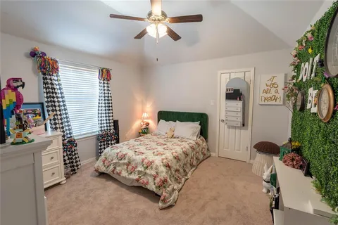 a bedroom with a bed dresser and a window