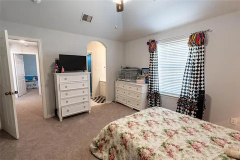 a bedroom with a bed and flat screen tv