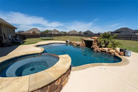 swimming pool view with a seating space