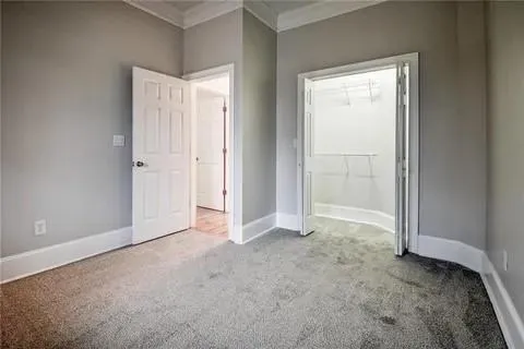 a view of an empty room and closet area