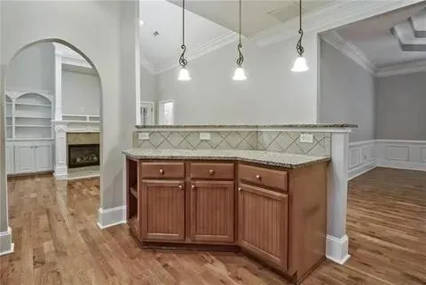 a view of a kitchen with a sink and dishwasher a oven with wooden floor