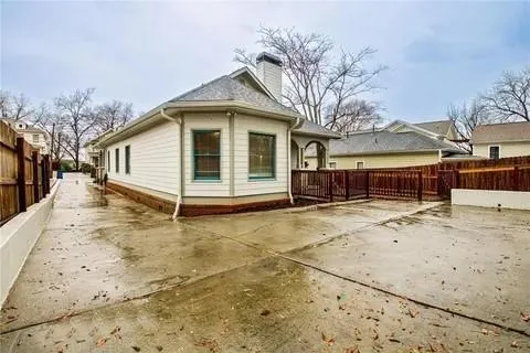 a view of a house with a yard covered in snow