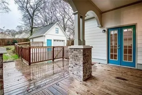 a view of a house with wooden deck