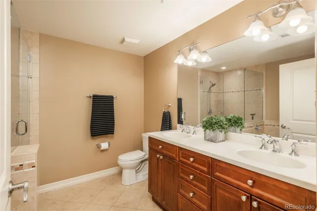 a spacious bathroom with a sink mirror and a toilet