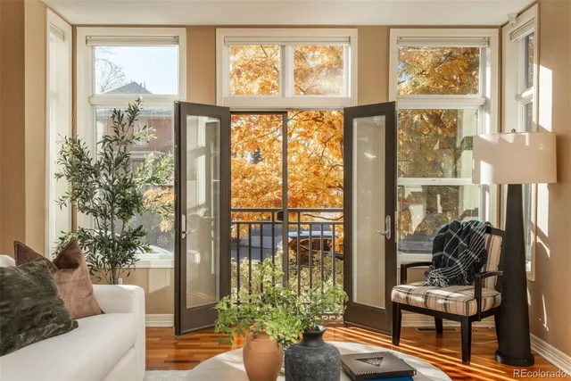 a living room filled with furniture and a large window
