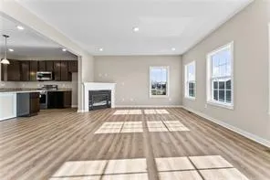 a view of a kitchen with a sink a refrigerator and window