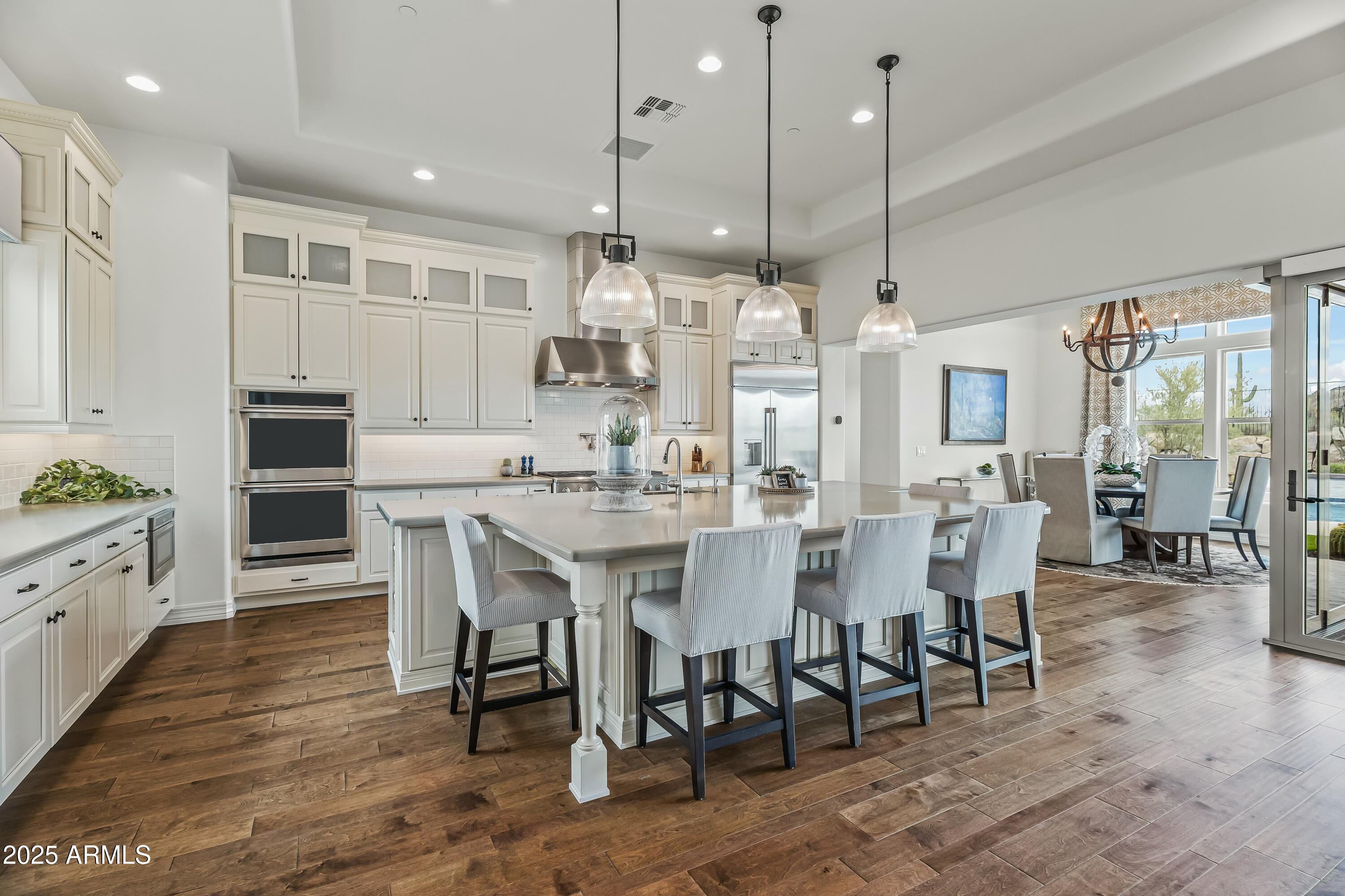 a large kitchen with a table and chairs