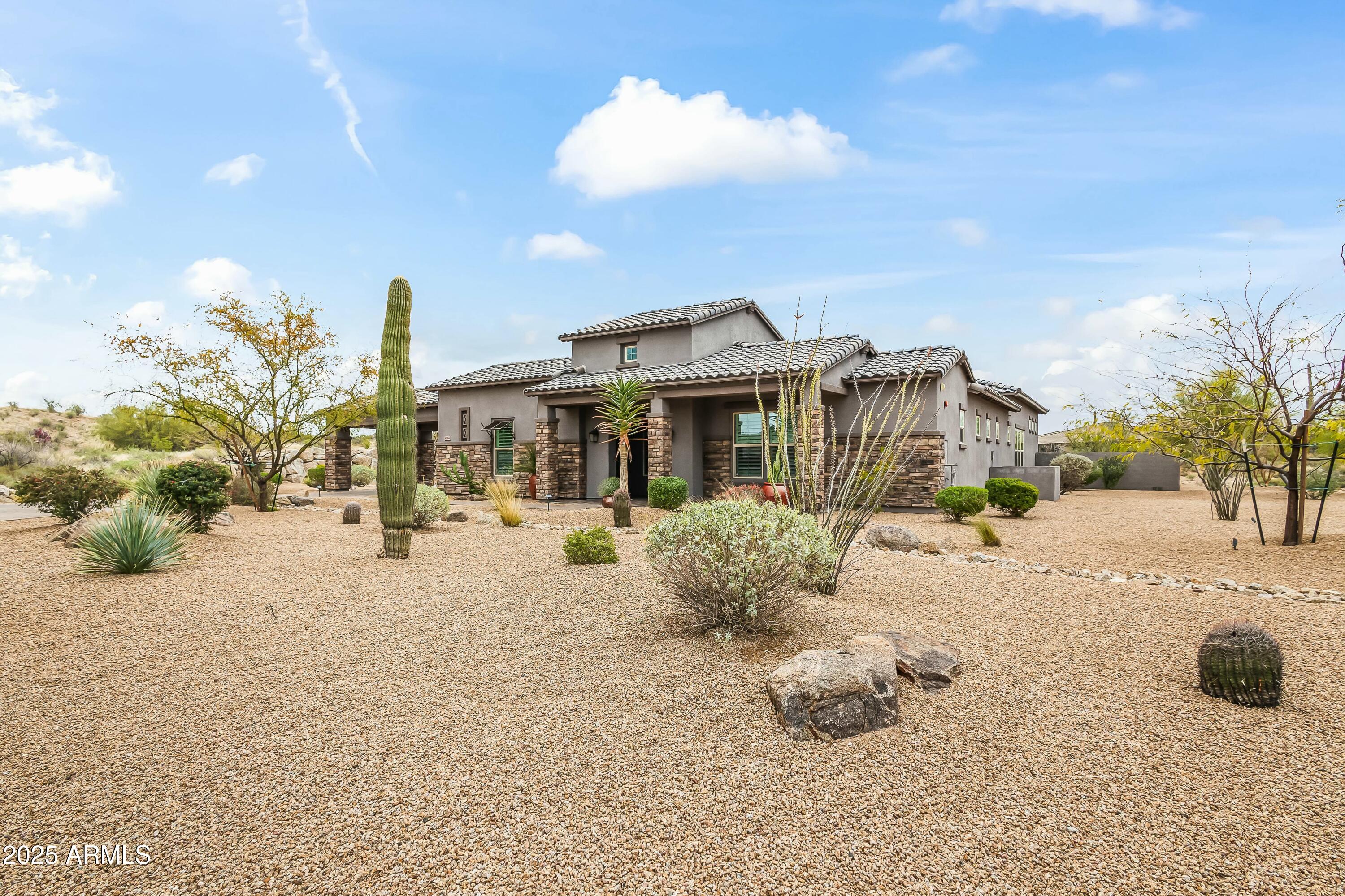 8769 East Granite Pass Road Scottsdale, AZ 85266 - Photo 12 of 23 a front view of a house with a yard and garage