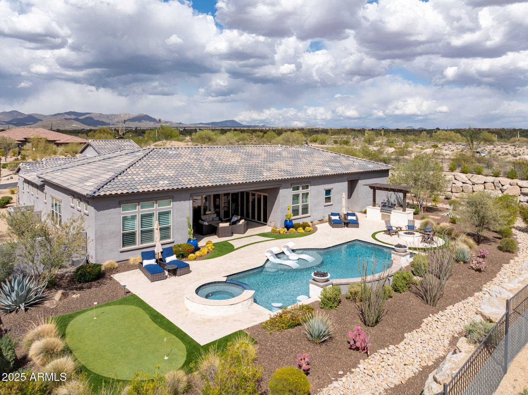 8769 East Granite Pass Road Scottsdale, AZ 85266 - Photo 13 of 23 a view of a house with pool and chairs