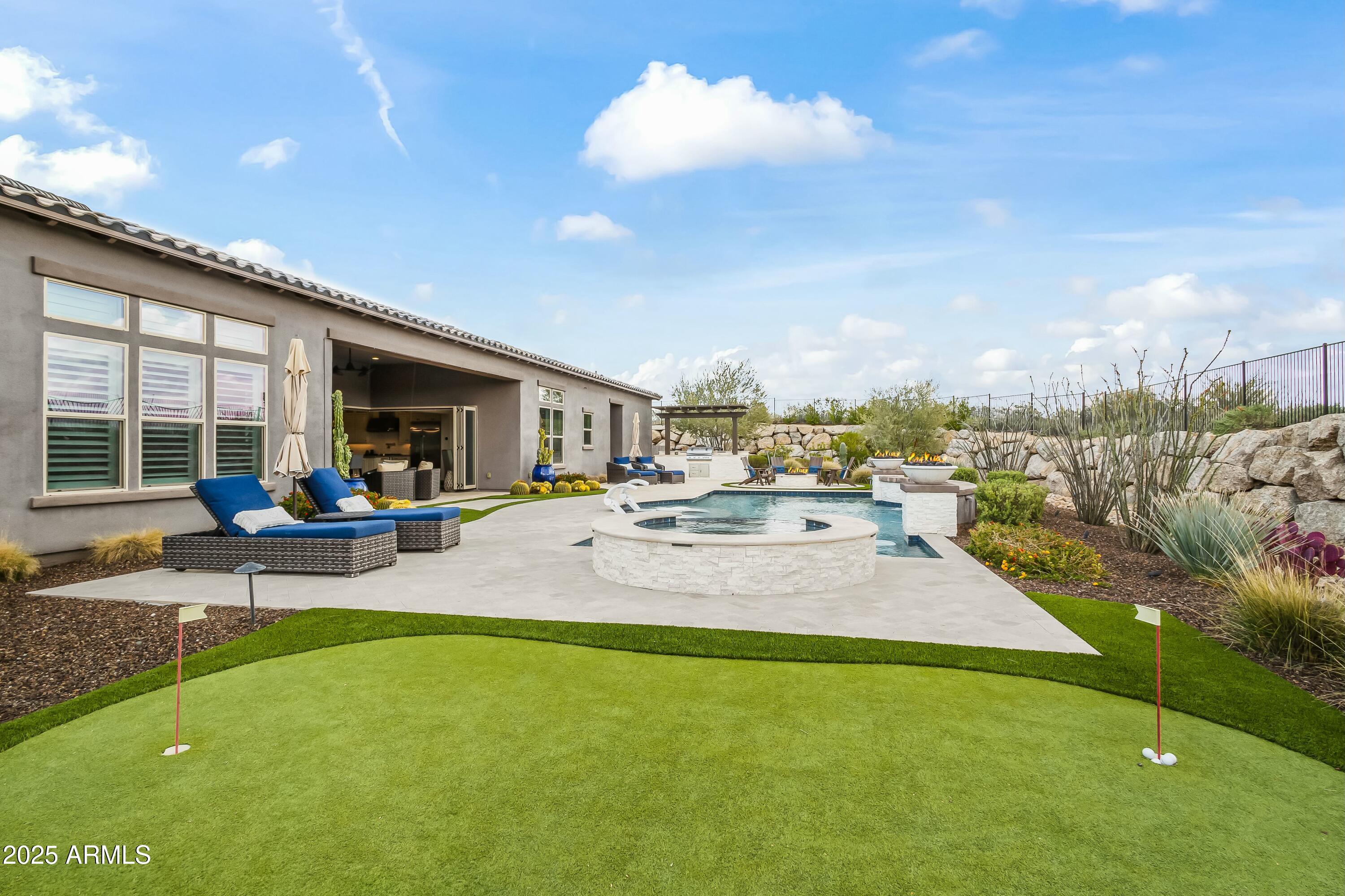8769 East Granite Pass Road Scottsdale, AZ 85266 - Photo 17 of 23 a view of a swimming pool and lounge chairs