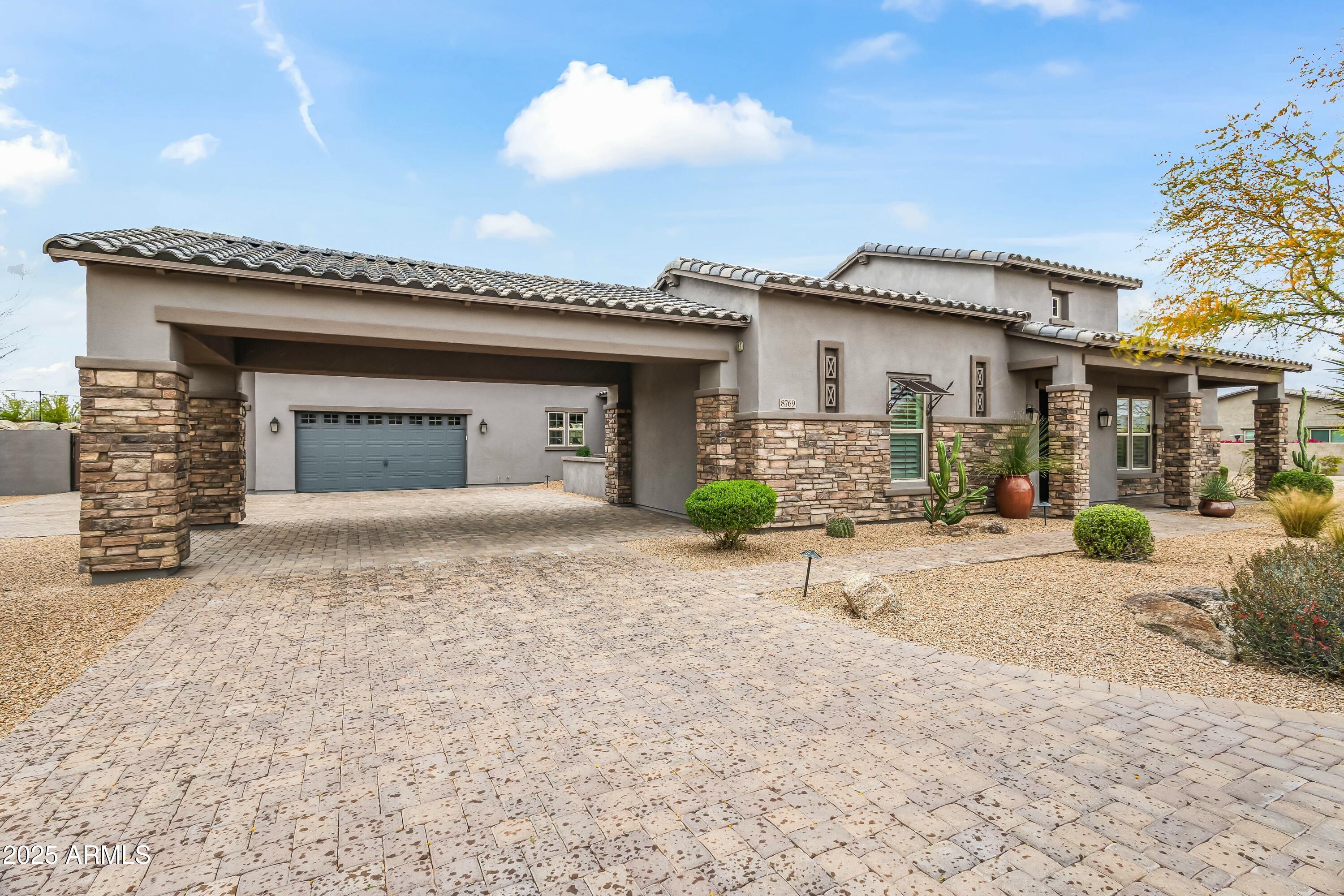 8769 East Granite Pass Road Scottsdale, AZ 85266 - Photo 22 of 23 a front view of a house with a yard and garage