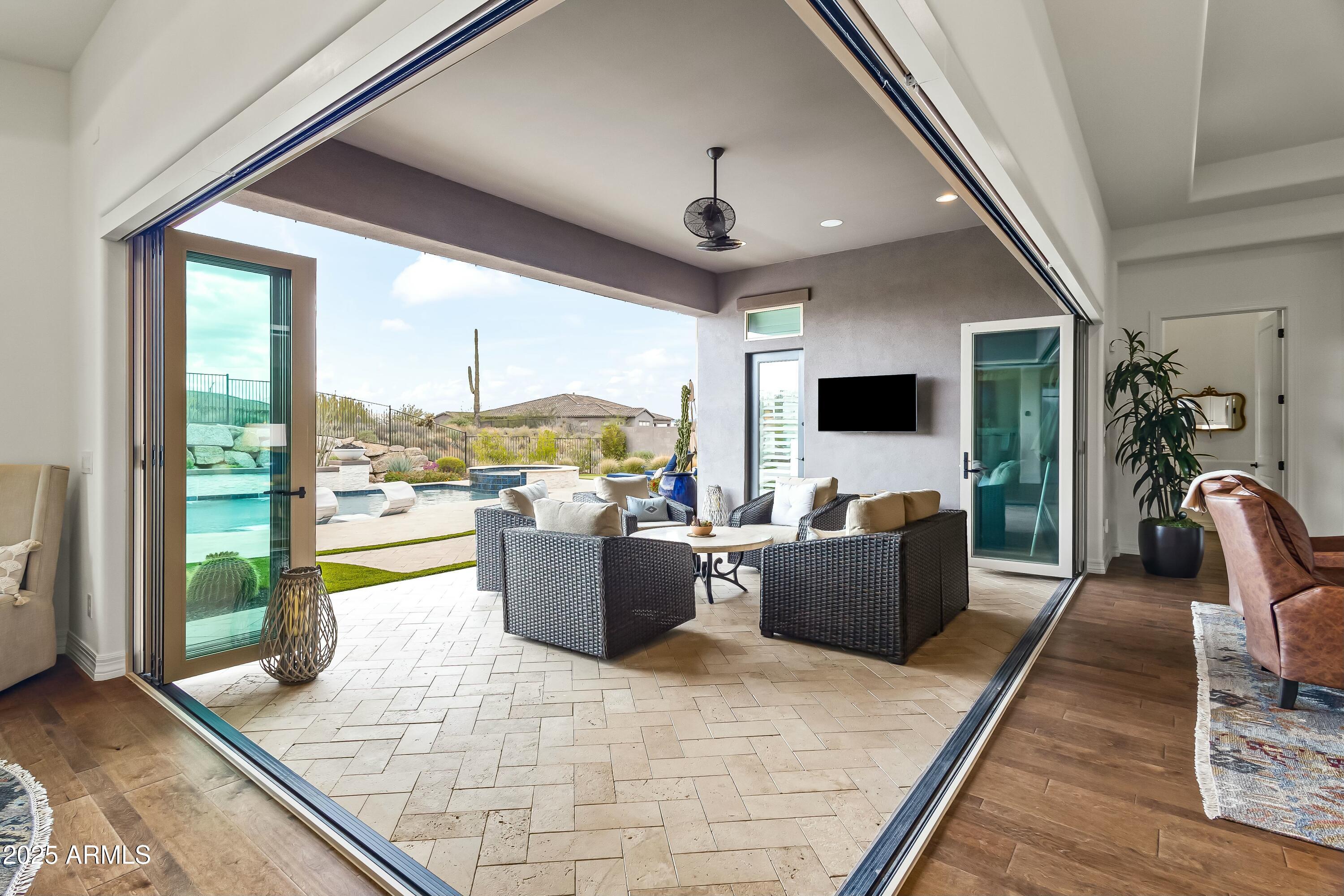 8769 East Granite Pass Road Scottsdale, AZ 85266 - Photo 5 of 23 a living room with couches a flat screen tv and a table
