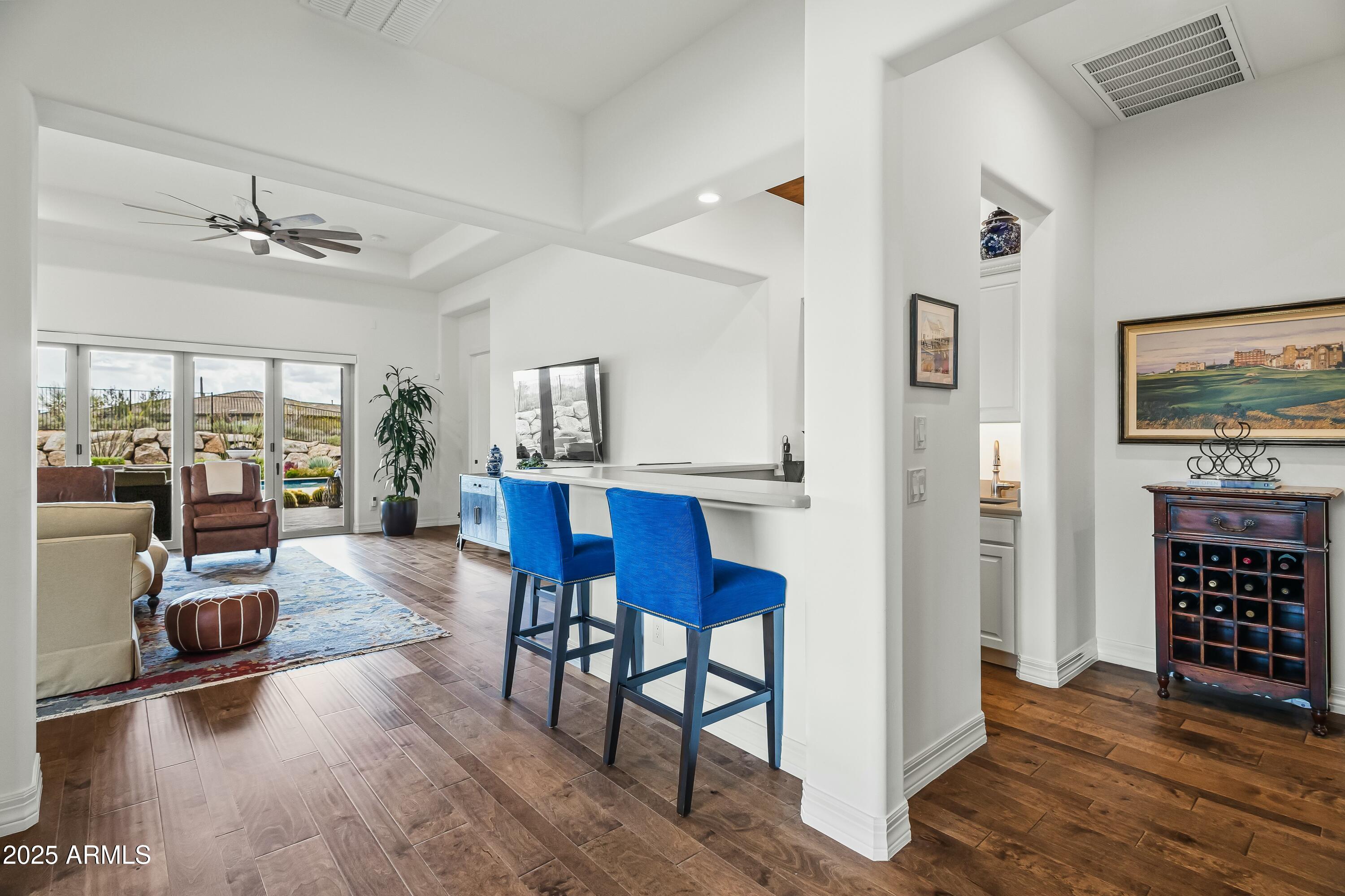 8769 East Granite Pass Road Scottsdale, AZ 85266 - Photo 7 of 23 a view of a livingroom with furniture a flat screen tv and floor to ceiling window